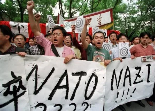 May 9th, 1999 AP file photo taken by Greg Baker showing student protestors outside the U.S. Embassy in Beijing after the May 7th US bombing of the Chinese Embassy in Belgrade, Serbia, which killed three Chinese journalists and injured dozens of diplomatic staff.